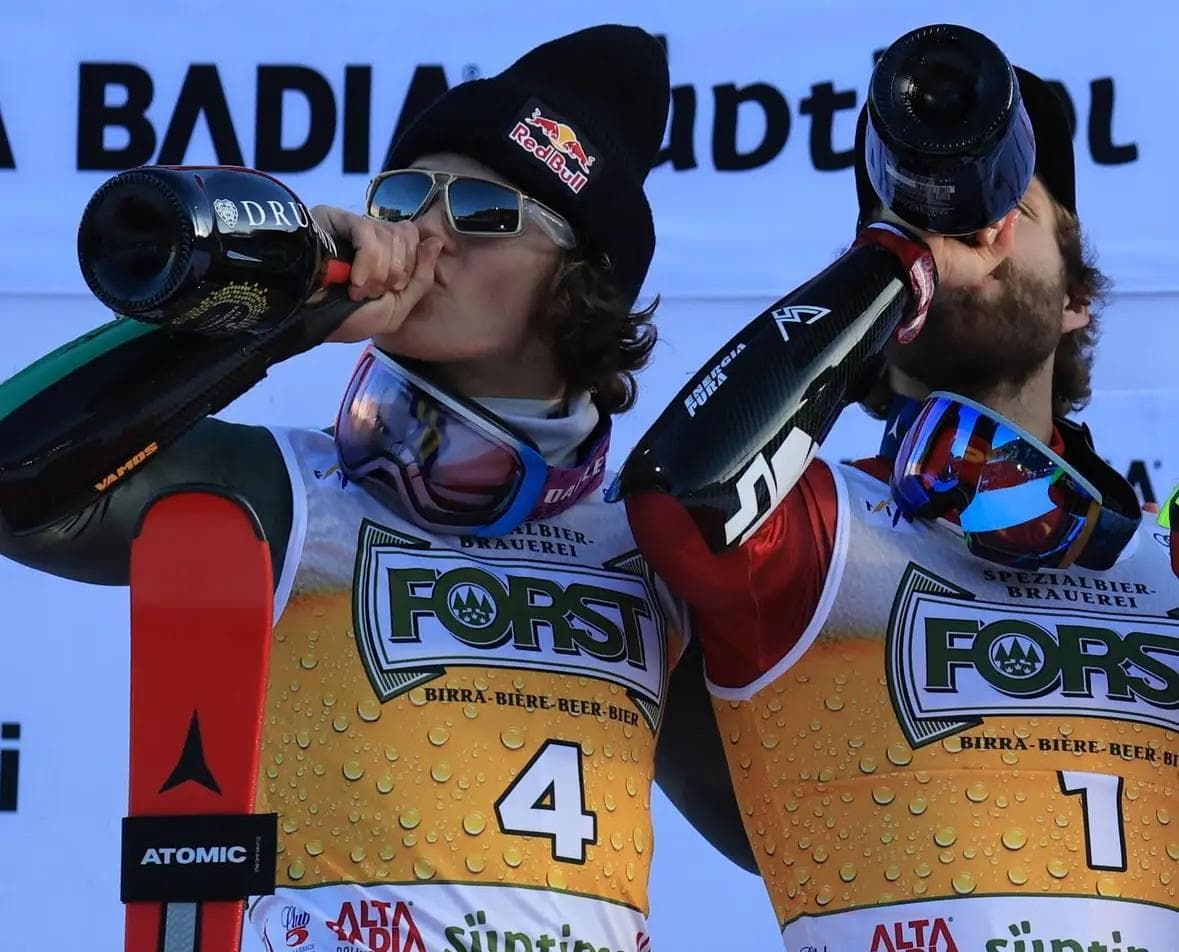 Lucas Braathen and Marco Schwarz showing their podium wins with champagne.
