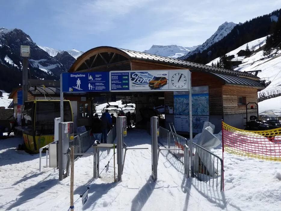 Ski resort chairlift carrying skiers and snowboarders up the mountain