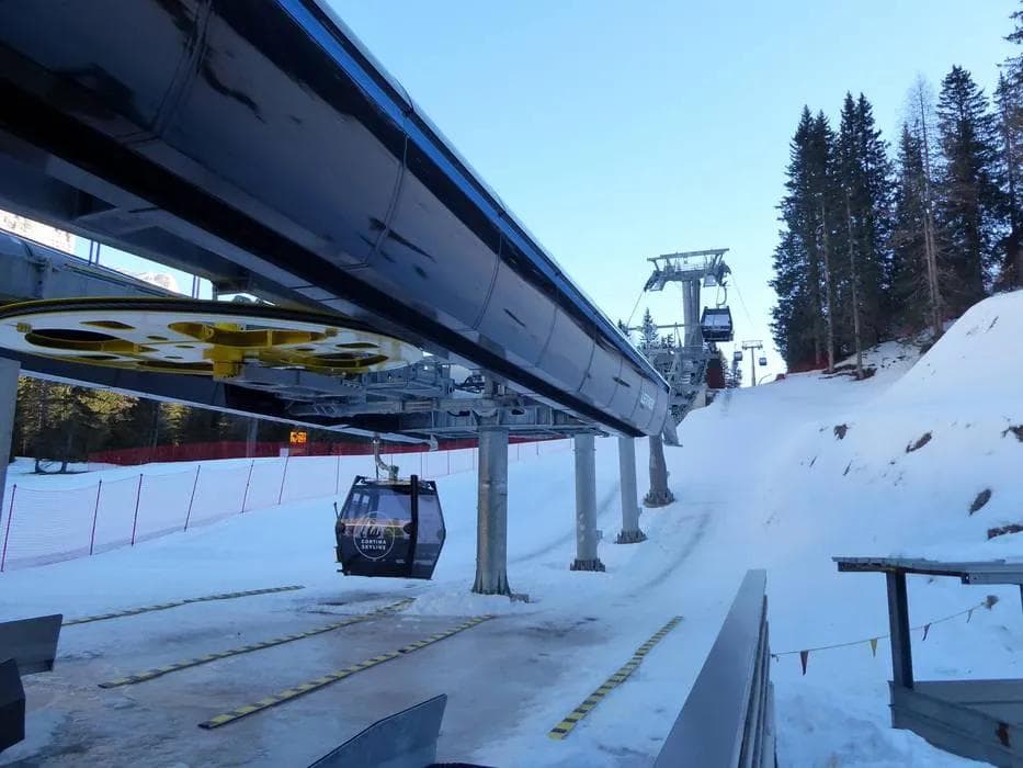 Ski resort chairlift carrying skiers and snowboarders up the mountain