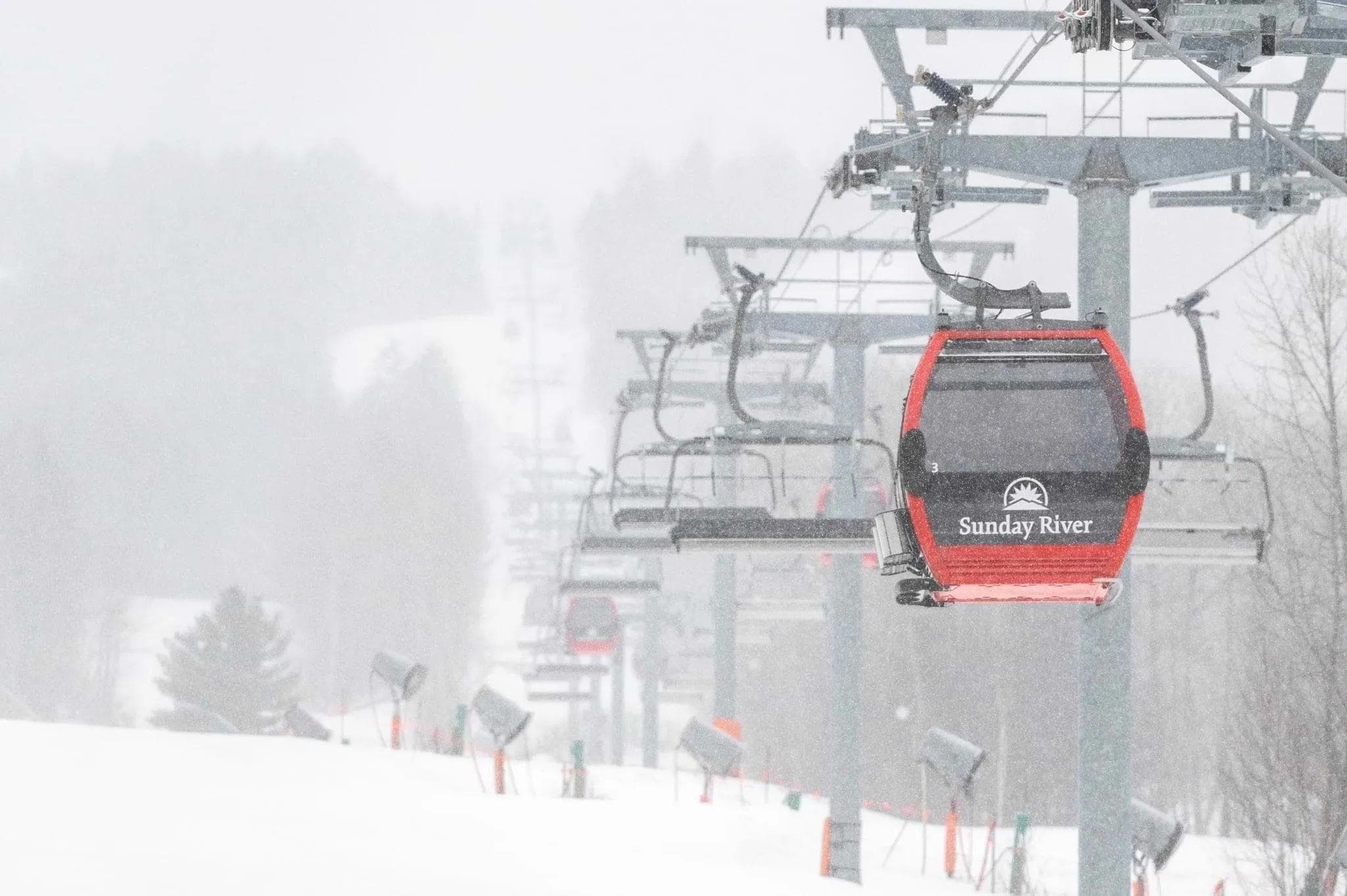 The red gondola at Sunday River standouts during a snowstorm.