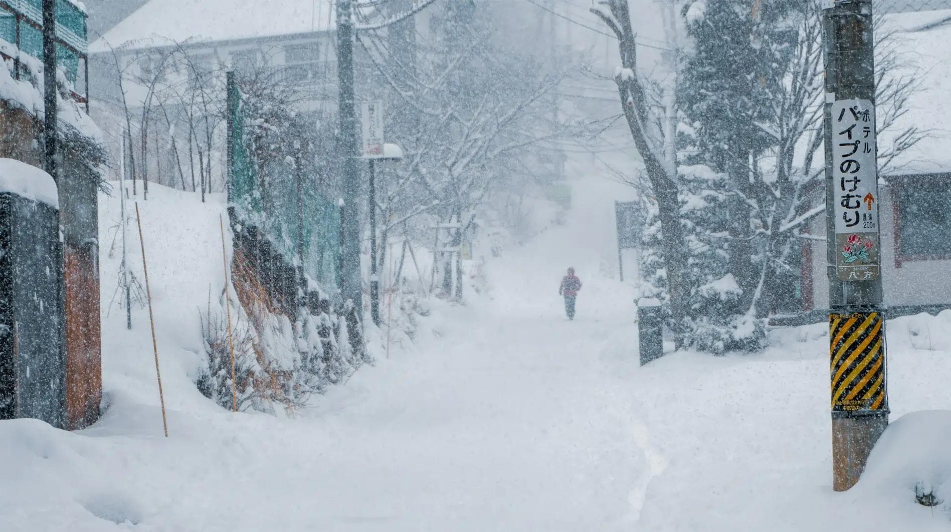 A lonely walker in the deep snow of Japan