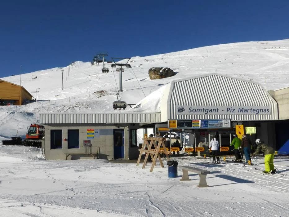 Ski resort chairlift carrying skiers and snowboarders up the mountain