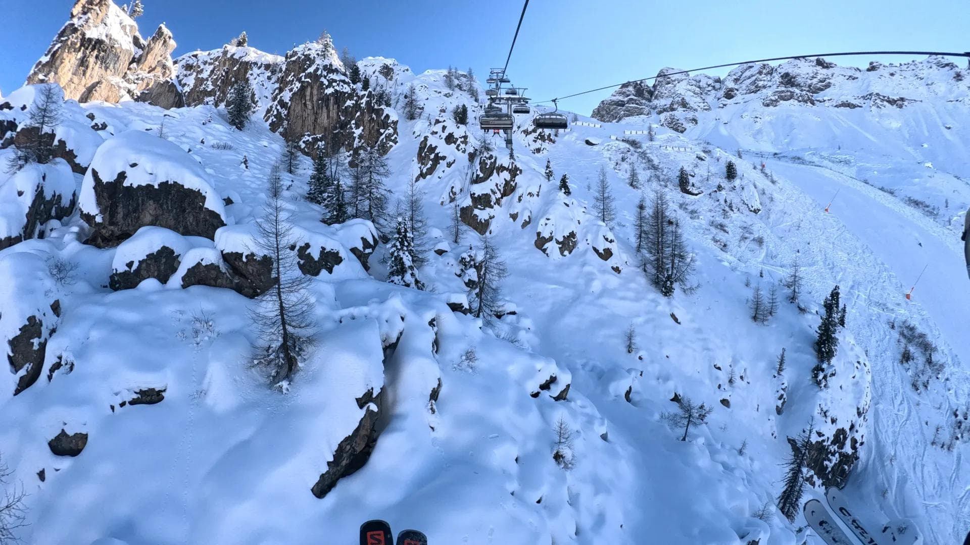 Riding a chairlift at Arabba surrounded by towering limestone peaks.