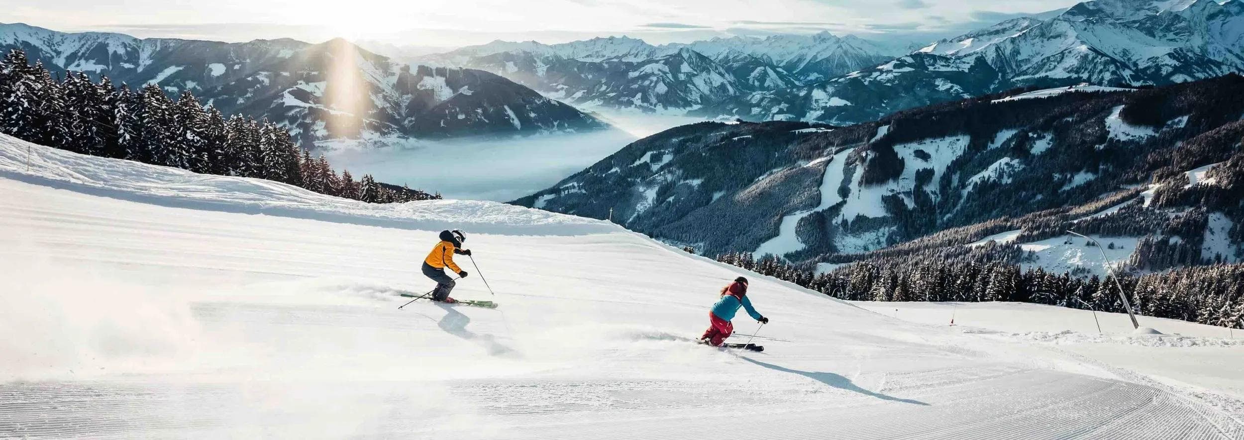 Skiers riding high above the Zell am See lake and village.