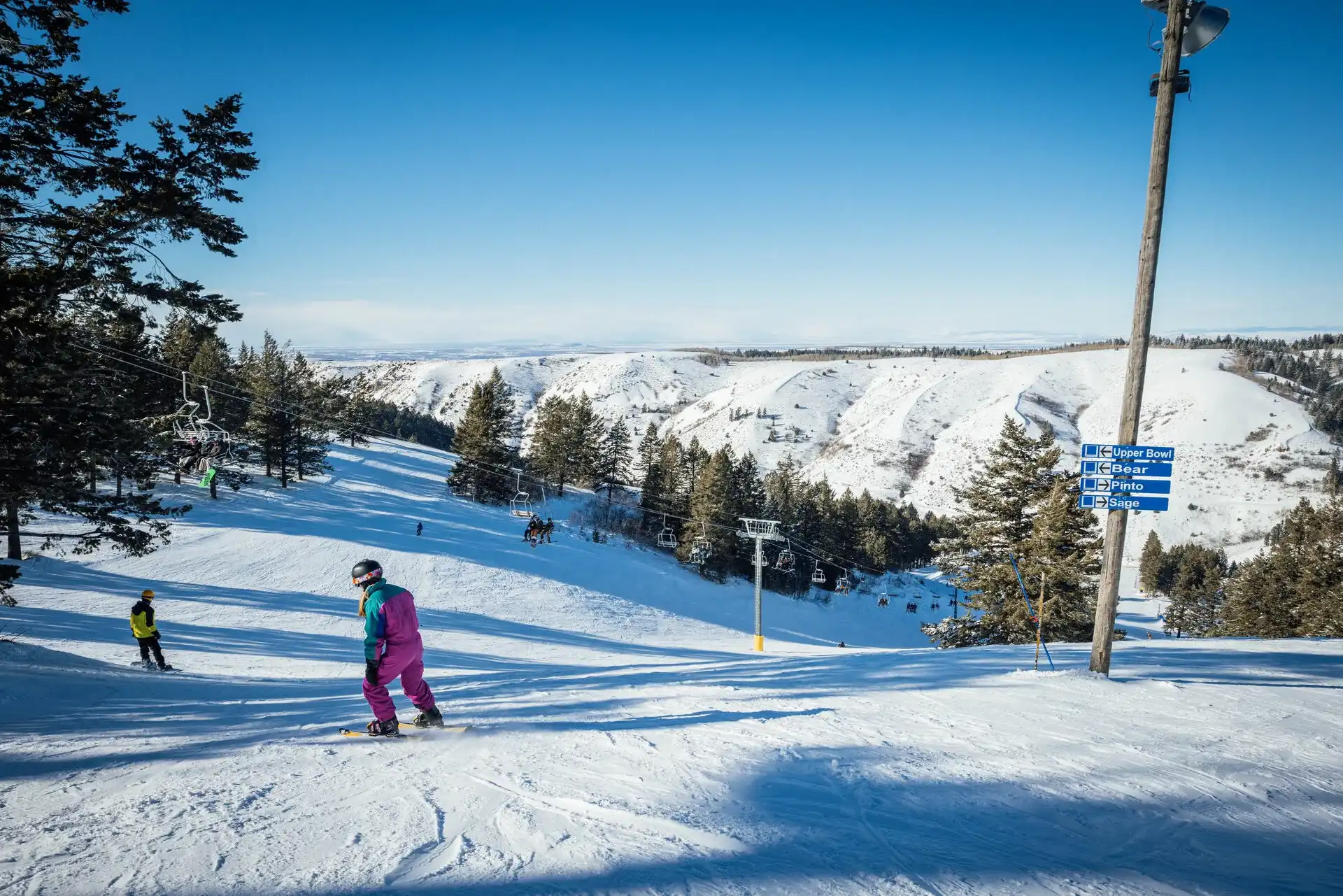 Skiers enjoying a perfect day at Kelly Canyon ski resort.